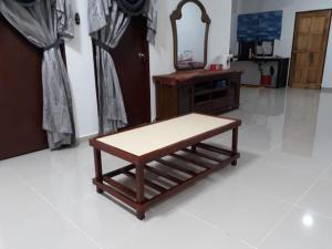 a wooden bench sitting in a room with a mirror at HOMESTAY KAPAR KLANG Homestay Balqis in Kapar