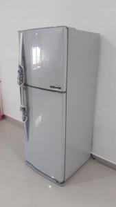 a white refrigerator sitting in a room at HOMESTAY KAPAR KLANG Homestay Balqis in Kapar