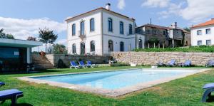 a house with a swimming pool in the yard at Quinta de Fiães - Agroturismo in Vilar de Maçada