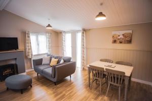 a living room with a couch and a table at Warrenwood Country Park in Polegate