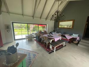 a living room with a table and a couch at Baviaanshoek in Keurboomstrand