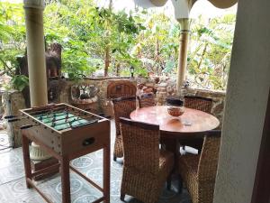 a table and chairs on a porch with a table and a game at Maison de rêve in Tabarka