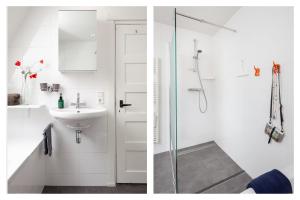 a white bathroom with a sink and a shower at Vakantiehuis Zeevonk in Bergen aan Zee +21 photos