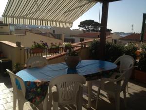 a blue table and chairs on a patio at Casa Laura in San Vito lo Capo