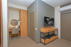 Zimmer mit einem Schreibtisch und einem Spiegel in der Unterkunft Cartez Hotel in Yerevan