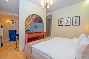 a bedroom with a bed and a flat screen tv at Cartez by Horizon Hotels, Yerevan in Yerevan