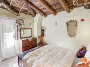 a bedroom with a large bed and a mirror at Belvilla by OYO Mulino in Piana di Forcella