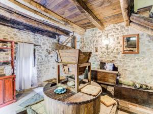 a room with a wooden chair in a room with stone walls at Belvilla by OYO Mulino in Piana di Forcella
