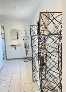 a display case in a room with a vase at Residence Louis Le Lavoir in Bains-les-Bains