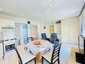 a kitchen and dining room with a table and chairs at Residence Louis Le Lavoir in Bains-les-Bains