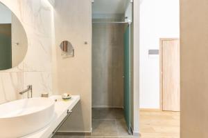 a bathroom with a sink and a shower at Ark 68 City Rooms in Rethymno Town