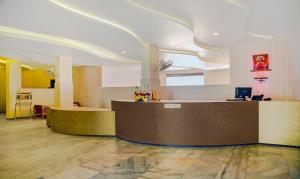 a lobby with a reception desk in a building at Treebo Trend Kumily Gate Thekkady in Thekkady