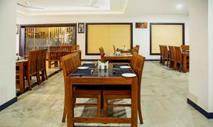 a dining room with a table and chairs at Treebo Trend Kumily Gate Thekkady in Thekkady