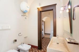 a bathroom with a sink and a toilet and a mirror at Hora Vona in Orosei +20 photos