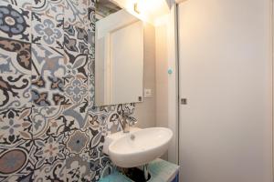 a bathroom with a sink and a mirror at Hora Mare in Orosei