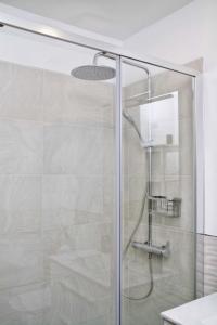 a shower with a glass door in a bathroom at Guajara in Las Lagunas