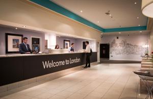 a welcome to london reception desk in a hotel lobby at Thistle Barbican Shoreditch in London