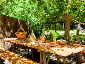 a picnic table with food and bottles and baskets on it at Belvilla by OYO Eremo di Fieri in Cortona