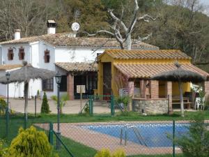 una casa con piscina frente a ella en Belvilla by OYO Can Rajoler, en Riudarenes