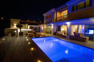 a house with a swimming pool at night at Luxury Villa Morelli with seaview & heated pool in Maspalomas