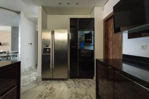 a kitchen with a large stainless steel refrigerator at Sapphire Luxury Villa in Iraklitsa