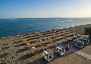 an overhead view of a beach with chairs and umbrellas at Enorme Teatro Beach - Adults Only in Amoudara Herakliou