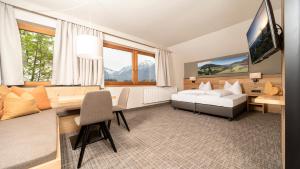 a hotel room with a bed and a desk at Hotel Stockerwirt in Reith im Alpbachtal