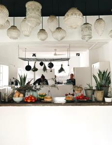 a kitchen with lots of potted plants and lights at The Richmond Café and Rooms in Richmond