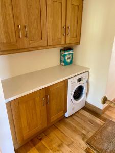 a kitchen with a washer and dryer on a counter at Torrans Cottage in Downings