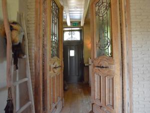 a hallway with two doors and a door with glass at Grand Holiday Home in Alphen with Sauna in Alphen