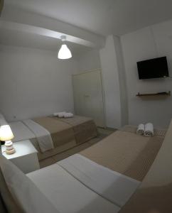 A bed or beds in a room at Aitherial Summer House