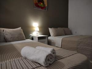 A bed or beds in a room at Aitherial Summer House
