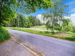 an empty road with trees on either side at Holiday Home near Ravel Cycling paths in Heuem
