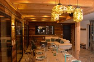 a dining room with a table and a couch at Chalet de charme, au calme, vue splendide, 15 personnes in Les Houches