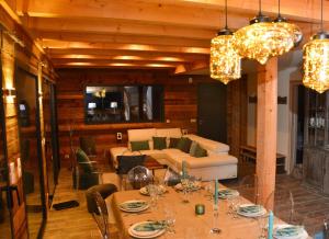 a living room with a table and a couch at Chalet de charme, au calme, vue splendide, 15 personnes in Les Houches