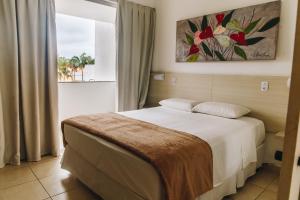 Postel nebo postele na pokoji v ubytování Jardim Atlântico Beach Resort + 37 fotografií