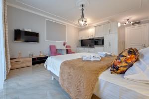 a bedroom with a large bed with towels on it at Adonis 2021 in Zlatibor