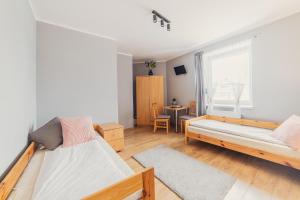 Posteľ alebo postele v izbe v ubytovaní Gościniec pod Lilijką