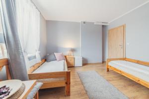Posteľ alebo postele v izbe v ubytovaní Gościniec pod Lilijką