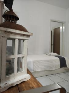 a bedroom with a bed and a lantern on a table at Aitherial Summer House in Vourvourou
