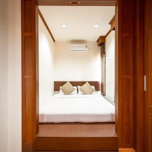Кровать или кровати в номере Hoteru House Ranong 2 - โฮเตรุ เฮ้าส์ ระนอง