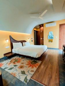 a bedroom with a large bed and a rug at Ekaa Villa near Taj Mahal in Agra