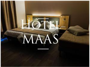 Postel nebo postele na pokoji v ubytování Hôtel MAAS