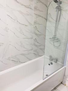 a bathroom with a shower with a glass door at 7 Guest 4 Bedrooms CITY CENTRE lovely home in Loughborough City Centre in Loughborough