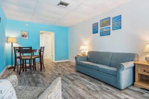 a living room with a couch and a table at Malibu Resort Motel in St. Pete Beach