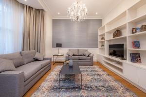 a living room with a couch and a table at Chesham Court Knightsbridge in London