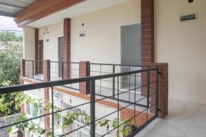 a balcony of a house with a staircase at RedDoorz Syariah @ Raya Punten Batu in Punten