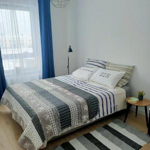 Posteľ alebo postele v izbe v ubytovaní Apartament PERŁA POŁUDNIA
