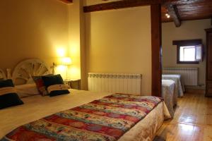 Postel nebo postele na pokoji v ubytování CASA RURAL LAS BODEGAS