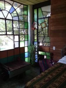 a room with a bed and stained glass windows at Barranca del Paraná in Paganini